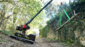 almac crane on slope holding timber